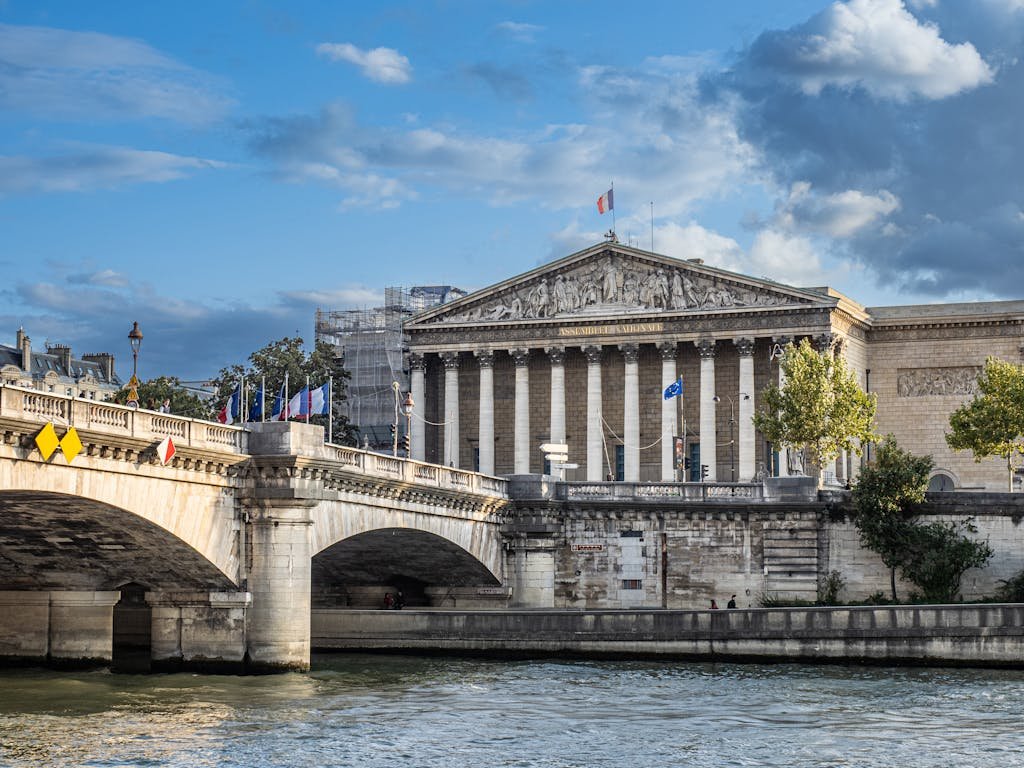 Stunning capture of the Palais Bourbon by the Seine River in Paris, showcasing classic French architecture.